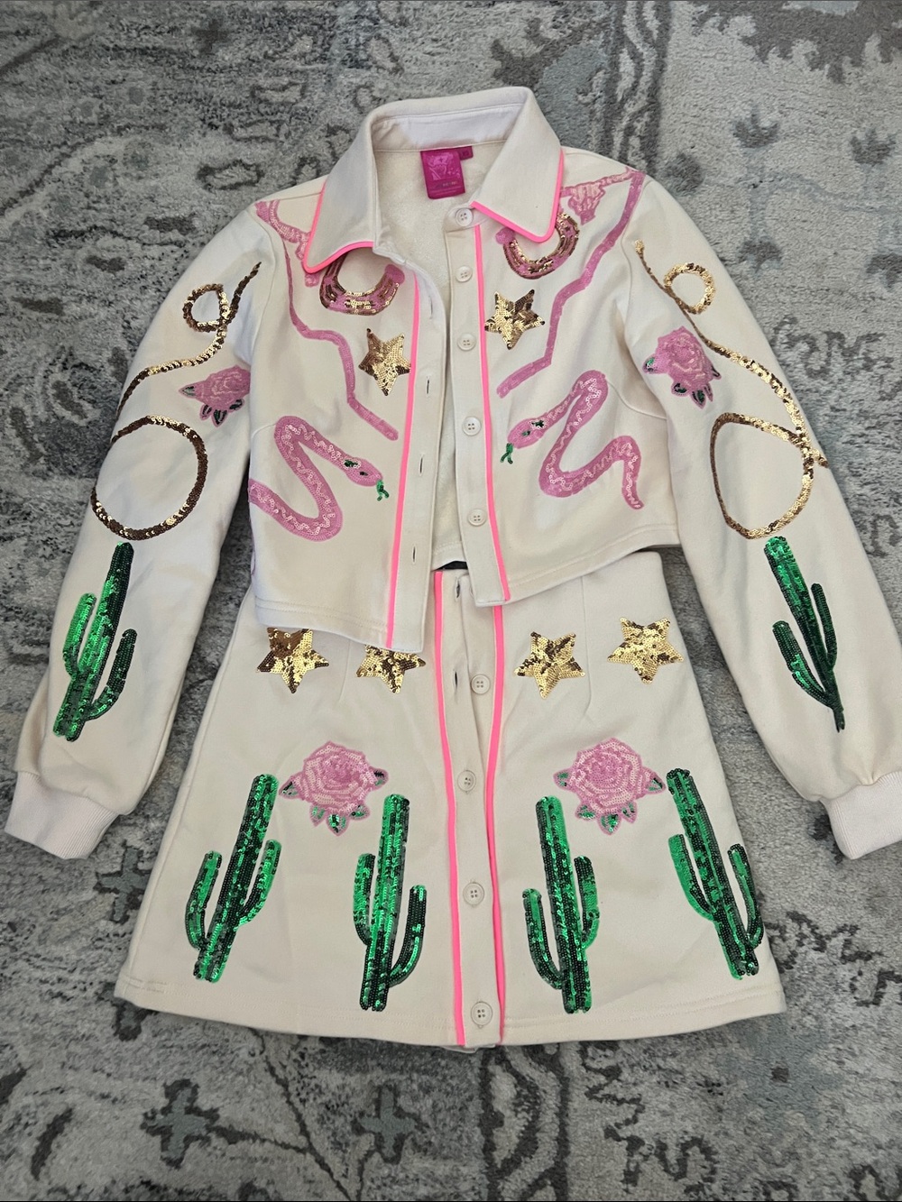 QUEEN OF SPARKLES Rodeo Cream Two-Piece Sequin Jacket and Skirt with Pink Trim
